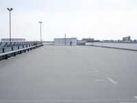 a boat is parked in an empty parking lot near an air port on the water