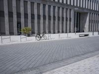 a sidewalk with benches on top of it next to buildings and a bicycle racket