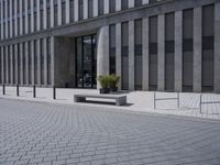 a sidewalk with benches on top of it next to buildings and a bicycle racket