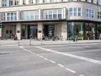 a building with a row of bikes in the front and the street in front that says no entry to bike path
