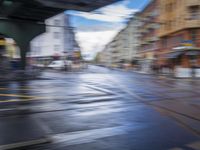 motion blur photograph of street and buildings, including road and pedestrian crossing, in an urban area