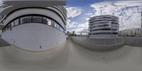 a fish eye lens view of the entrance to a building in a city center with a ramp