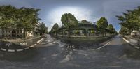 a wide angle panoramic view of a city street with an upside down bridge