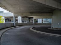 a car is driving on the highway through an underground parking garage area in a city