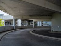 a car is driving on the highway through an underground parking garage area in a city