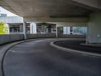 a car is driving on the highway through an underground parking garage area in a city