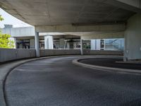 a car is driving on the highway through an underground parking garage area in a city