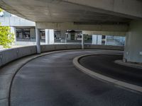 a car is driving on the highway through an underground parking garage area in a city