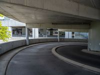 a car is driving on the highway through an underground parking garage area in a city