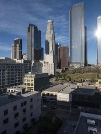 a large white building with lots of windows is standing in the middle of a big city