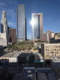 a large white building with lots of windows is standing in the middle of a big city