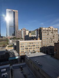 a large white building with lots of windows is standing in the middle of a big city