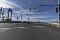 a picture from a car looking at the road and traffic lights of the city area