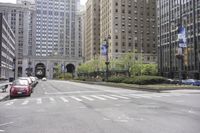 an intersection of cars, street lights and tall buildings in the city of chicago's heart