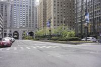 an intersection of cars, street lights and tall buildings in the city of chicago's heart