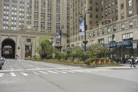 an intersection of cars, street lights and tall buildings in the city of chicago's heart