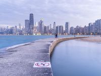 the skyline of chicago with no swimming sign at the edge of a pier at dusk