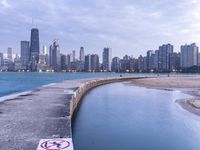 the skyline of chicago with no swimming sign at the edge of a pier at dusk