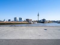 parking lot with truck on side and buildings along it and blue sky with no clouds in background