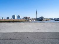 parking lot with truck on side and buildings along it and blue sky with no clouds in background