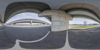 a fish eye lens of a street with overpasses and overpasss in the background