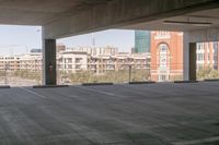 the floor and top is empty in this parking space with tall buildings in the background