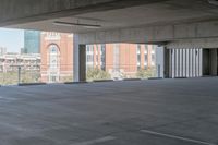 the floor and top is empty in this parking space with tall buildings in the background