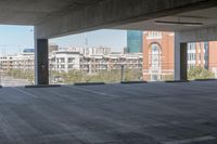 the floor and top is empty in this parking space with tall buildings in the background