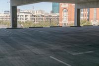 the floor and top is empty in this parking space with tall buildings in the background