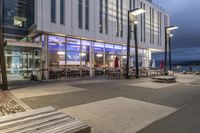 a picture of a place with benches in it's open space near a building