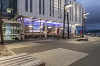 a picture of a place with benches in it's open space near a building