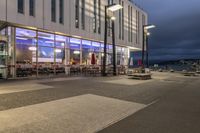 a picture of a place with benches in it's open space near a building