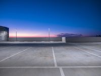 an empty parking lot with a sky background at dusk above the beach on a clear day