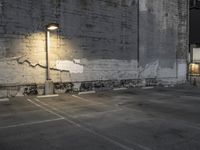 a concrete parking lot with a building in the back ground and street lights on top of it