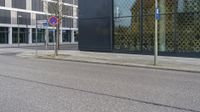 a city street with an empty street sign next to a building with a sign on it