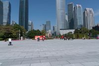 tall buildings with a blue sky in the background and people on the street on bicycles