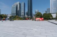 tall buildings with a blue sky in the background and people on the street on bicycles