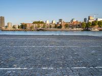 there is a woman that is standing with a skateboard by the water in the city