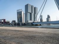 the large bridge over the water is surrounded by other skyscrapers and boats in the harbor