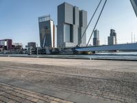 the large bridge over the water is surrounded by other skyscrapers and boats in the harbor