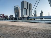 the large bridge over the water is surrounded by other skyscrapers and boats in the harbor