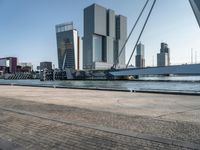 the large bridge over the water is surrounded by other skyscrapers and boats in the harbor