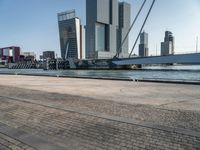 the large bridge over the water is surrounded by other skyscrapers and boats in the harbor