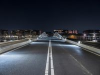 a city at night has lots of lights on it and on the street you can see traffic and bridge