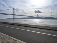 Cityscape of Lisbon, Portugal with Sunny Sky and Coastal Bridge