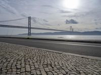 Cityscape of Lisbon, Portugal with Sunny Sky and Coastal Bridge