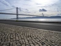 Cityscape of Lisbon, Portugal with Sunny Sky and Coastal Bridge