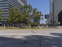 street view of a quiet city street with no traffic lights on it and tall buildings behind