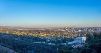 the city is surrounded by trees in this image and it appears to be being a beautiful area