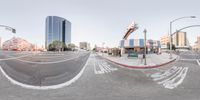 this is a panoramic photo taken in the daytime sky with an empty street at the end